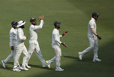 Indian cricket captain Virat Kohli  and teammates leave ground on tea break during the third day of the second cricket test match between India and West Indies in Hyderabad | AP
