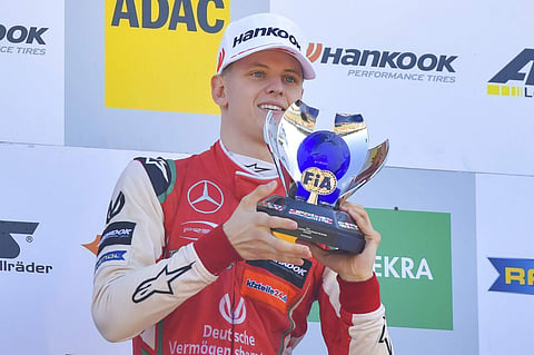 Mick Schumacher, son of former multiple Formula One champion Michael Schumacher raises the trophy as overall winner in FIA Formula 3 European Championships at Germany's Hockenheim | AP