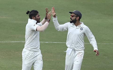 Indian pacer Umesh Yadav with skipper Virat Kohli (Photo | AP)