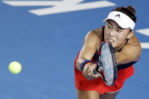 Wang Qiang of China hits a return during her women's singles semi-final match against Garbine Muguruza of Spain at the Hong Kong Open tennis tournament on October 13, 2018.  | AFP