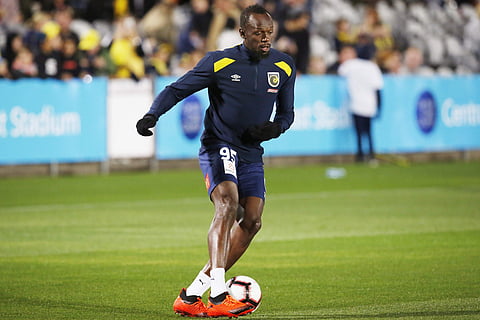 Usain Bolt warms up before a friendly trial match (File | AP)