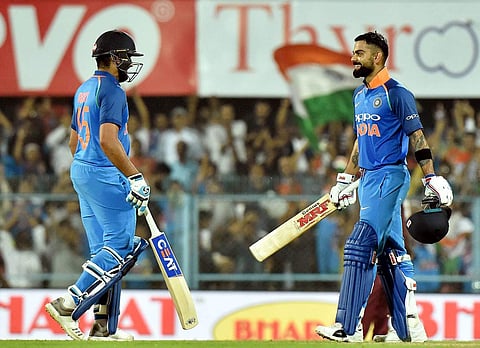 Indian cricket team Captain Virat Kohli celebrates his century with teammate Rohit Sharma during the first One Day International cricket match against West Indies at ACA Cricket Stadium Barsapara in Guwahati Sunday Oct 21 2018. | PTI