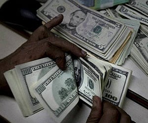 PTI file photo of dollars being counted used for representational purpose only