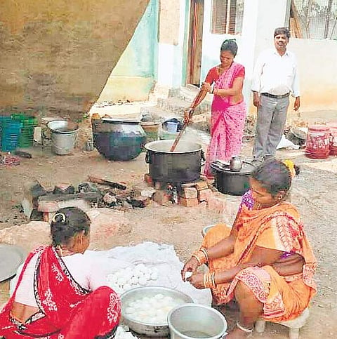 Midday meal workers cooking food in the open at Edupuram in Ichchapuram mandal on Saturday | Express