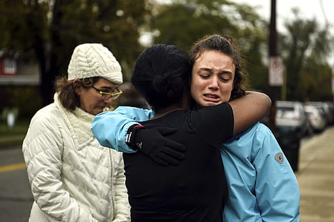 Survivors and kin of victims cry after a deadly shootout near a Jewish synagogue in Pittsburgh, USA on 28 October 2018. (Photo | AP)