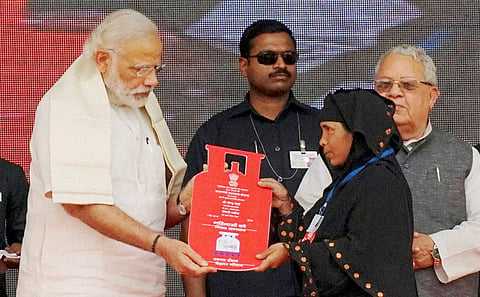 Prime Minister Narendra Modi presents cooking gas connection to a woman of Below Poverty Line (BPL) family during a launch of  Pradhan Mantri Ujjwala Yojana. (File Photo)