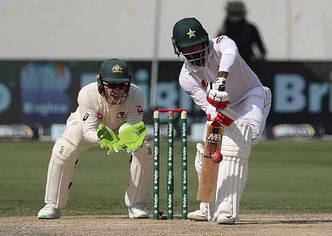 Pakistan cricketer Mohammad Hafeez (R) bats on day one of the 1st test cricket match between Australia and Pakistan at the Dubai International Cricket Stadium in Dubai. (Photo | AFP)