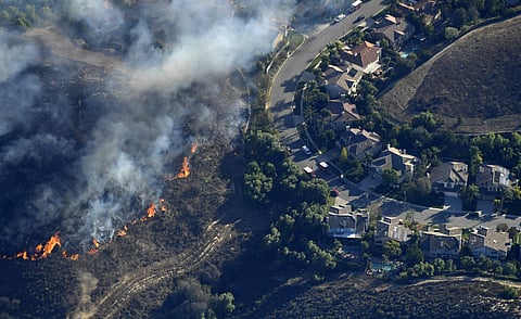 A fast-moving wildfire across Northern California's Butte County burned a hospital, hundreds of homes and left five dead on Friday. (Photo | AP)