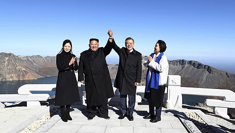 South Korean President Moon Jae-in, second from right, and his wife Kim Jung-sook, right, stand with North Korean leader Kim Jong Un, second from left, and his wife Ri Sol Ju on the Mount Paektu in North Korea, Sept. 20, 2018. (Pyongyang Press Corps Pool 