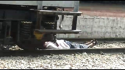 As the train passed away, the man calmly rose to his feet and walked away not before getting an earful from the passengers, who watched the train passing over the man with shock, at the platform. | Express Photo Service