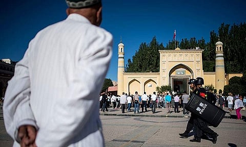 File photo of men arriving at a Mosque for the morning prayer  in China's Xinjiang Uighur Autonomous Region. (Photo| AFP)