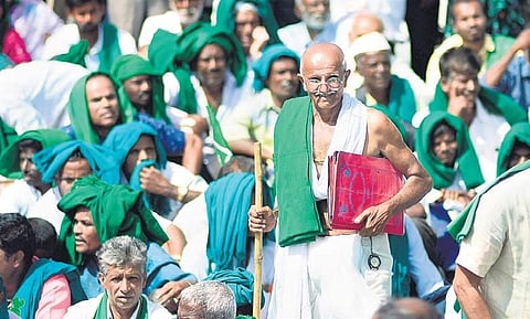 A farmer dressed as Mahatma Gandhi takes part in a protest by cane growers demanding that the state government clear their arrears, in Bengaluru on Monday | Shriram BN