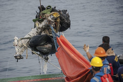 Rescuers use crane to retrieve part of the landing gears of the crashed Lion Air jet from the sea floor in the waters of Tanjung Karawang, Indonesia, Sunday, Nov. 4, 2018. | AP