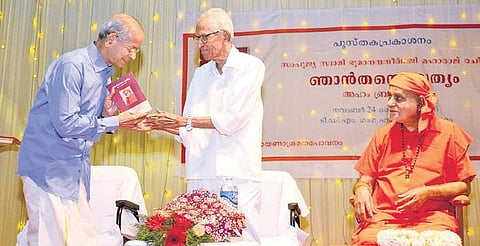 Critic and writer M K Sanu handing over a copy of the book to DMRC principal adviser E Sreedharan