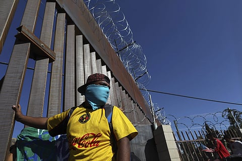 Migrants gather at the Mexico-U.S. border after getting past a line of Mexican police at the Chaparral crossing in Tijuana, Mexico, Sunday, Nov. 25, 2018, as they try to reach the U.S.  (Photo | AP)