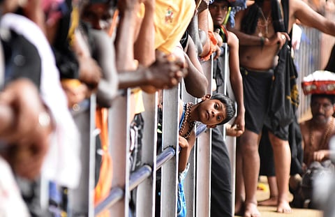 A devotee anxiously waiting at Valiya Nadapanthal for darshan at Sabarimala Lord Ayyappa temple on Monday (Photo | EPS/BP Deepu)