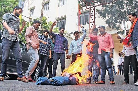 Supporters of State BJP spokesperson Koradala Naresh burn Yoganand   in effigy at BJP State office, in Hyderabad on Friday; (right) Dhanpal Suryanarayana Gupta’s followers damage chairs in Nizamabad party office  |S Senbagapandiyan