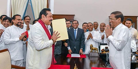 File photo of Mahinda Rajapaksa greeting President Maithripala Sirisena after being sworn in as the new Prime Minister of Sri Lanka on 2 October
