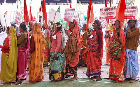 Farmers hold placards ahead of their march from Ramlila Maidan towards Parliament in New Delhi | PTI