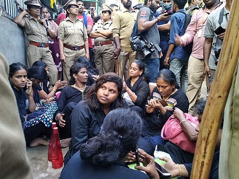 Women group at Pamba amid tight police security waiting to trek their way to the holy shrine.  (Photo | Special Arrangement)