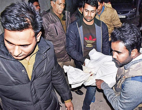 NIA officials carry seized articles after raids at Seelampur in north-east Delhi on Wednesday | PTI