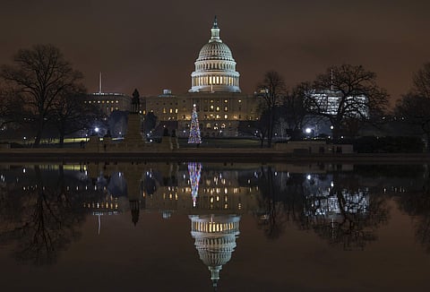 The Capitol is mirrored in the Reflecting Pool in Washington, as a partial government shutdown heads into a second week, Friday night, Dec. 28, 2018.  (Photo | AP)