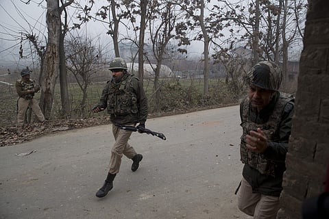 Indian paramilitary soldiers runs for cover during a protest near the site of a gunbattle in Chattergam area of Budgham, about 25 Kilometers from Srinagar, Indian controlled Kashmir, Wednesday, Nov. 28, 2018. | AP