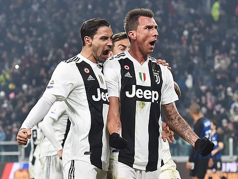 Juventus' Mario Mandzukic, right, celebrates with teammate Mattia De Sciglio, left, and Paulo Dybala after scoring his side's opening goal during the Serie A soccer match between Juventus and Inter Milan at the Turin Allianz stadium, Italy, Friday, Dec. 7