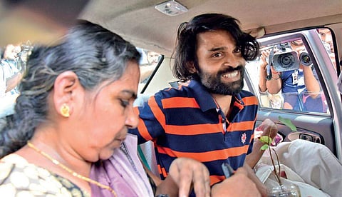 Sreejith leaving in a car from the pavement in front of  the Secretariat on Wednesday, along with his mother Remani, after ending indefinite stir, fondly holding a tree sapling which he had nurtured while he was on the mission demanding a CBI probe into t
