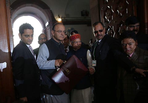 Union Finance minister Arun Jaitley holds a briefcase containing federal budget documents as he arrives to present the budget in Parliament house accompanied by MOS Finance Shiv Pratap Shukla in New Delhi on Thursday. (EPS | Shekhar Yadav)