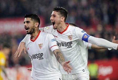 Sevilla midfielder Ever Banega (L) is to miss the upcoming La Liga matches against Girona and Las Palmas. | AP