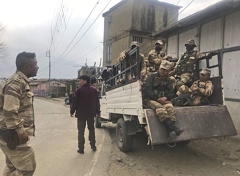 Nagaland police personnel keep guard outside a polling station during the Nagaland state legislature elections in Kohima village, Tuesday  - AP Photo