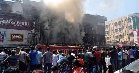 Firefighting team douse fire at City Style in Cuttack. (EPS)