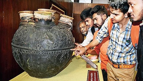Visitors examine ancient instruments that are on display at the exhibition being organised in the anthropology section of the Chennai Museum | Express