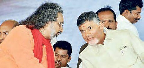 Swami Amritaswarupananda Puri speaking to Naidu during Amrita varsity’s foundation stone-laying ceremony in Guntur, on Wednesday   | Express