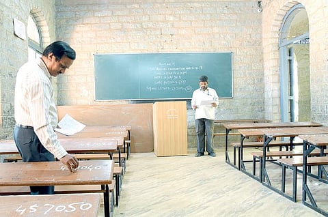 Faculty member of a college allotting register numbers for PU II annual exams scheduled from Thursday, at the Government PU College, in Malleswaram in Bengaluru. Image used for representational purposes only. 