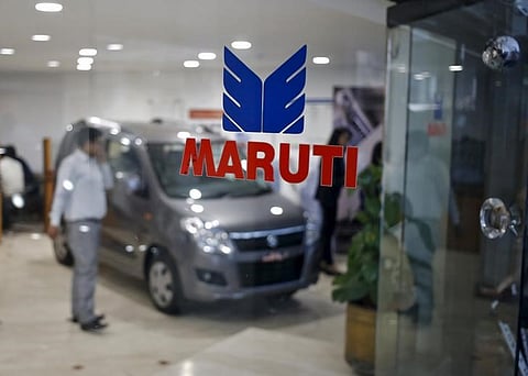 The logo of Maruti Suzuki India Limited is seen on a glass door at a showroom in New Delhi. (File photo | Reuters)