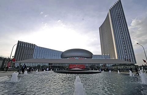 In this photo provided by China's Xinhua News Agency people gather before a red banner written in English and Chinese set up for the opening ceremony of the African Union Conference Center in Addis Ababa, Ethiopia, on Jan. 28, 2012. (AP)