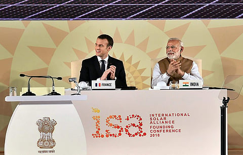 Prime Minister Narendra Modi and French President Emmanuel Macron clap at the International Solar Alliance Founding Conference in New Delhi. (Photo | PTI)