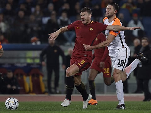 Roma's Edin Dzeko is fouled by Shakhtar's Ivan Ordets during a Champions League round of 16 second-leg soccer match between Roma and Shakhtar Donetsk, at the Rome Olympic stadium, Tuesday, March 13, 2018.  | AP