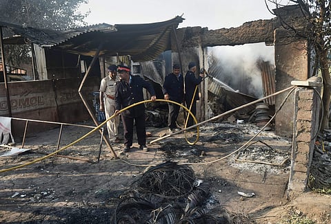 Fire men at a charred shop following the violence during celebrations of 200th anniversary of the Battle of Bhima Koregaon, near Pune. (PTI file photo)
