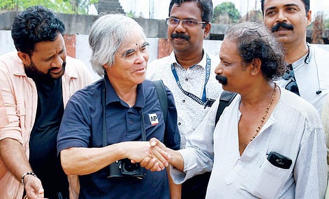 Mohanan Parameswaran, a veteran news photographer, interacting with  Pulitzer Prize-winning war photographer Nick Ut in Alappuzha on Tuesday.  Resul Pookutty is also seen  | Express