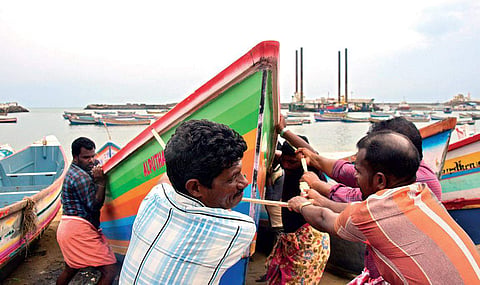 Fishermen bringing to safe zone their boats at the Vizhinjam harbour in Thiruvananthapuram following a fishing ban imposed by the state government till Thursday in the wake of a warning from the Met Department | B P Deepu