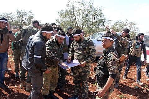 Turkey-backed Free Syrian Army fighters advance in Der Mismis village at the south east of Afrin, Syria. | AP