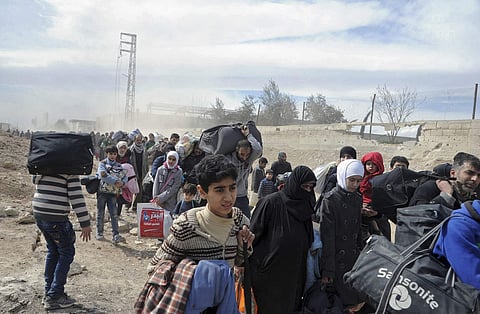 This photo released by the Syrian official news agency SANA, shows Syrian civilians with their belongings, fleeing. (Photo | AP )