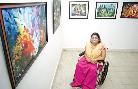 Sunitha Thrippanikkara with her paintings at Vyloppilly Samskrithi Bhavan  B P Deepu
