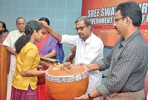 Kochi-based businessman V V Kasthurirangan handing over a Veena to student of Sri Swathi Thirunal College of Music as part of donating  musical instruments to the college students in Thiruvananthapuram. College principal Susheela C J is also seen | Manu R