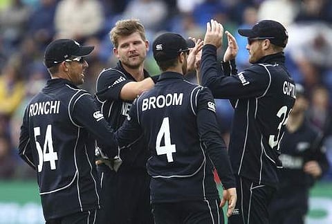 New Zealand's Corey Anderson (2nd L) celebrates with teammates after taking the wicket of England's Joe Root during the ICC Champions Trophy match between England and New Zealand at Sophia Gardens cricket ground in Cardiff south Wales on June 6, 2017. | A