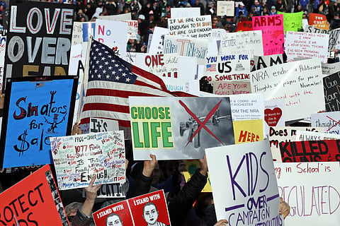 Crowds of people hold signs at the 'March for Our Lives' rally in support of gun control. (AP)