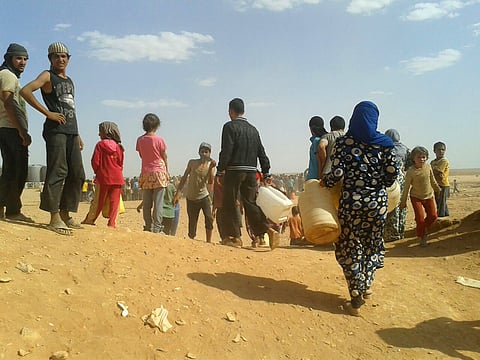 A file image of Syrian refugees gathering for water at the Rukban refugee camp in Jordan. (File | AP)